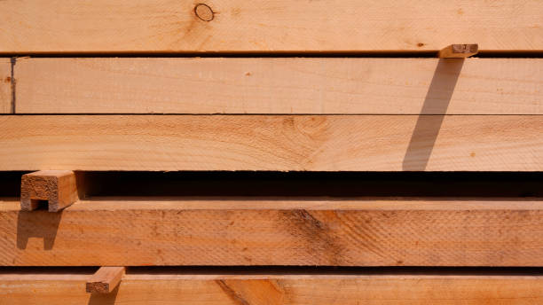 istock Rows of big hardwood timbers stacked in horizontal pattern, wood construction material background 2150907678