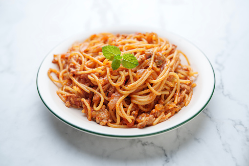 Spaghetti with tomato and minced pork meat served on a plate