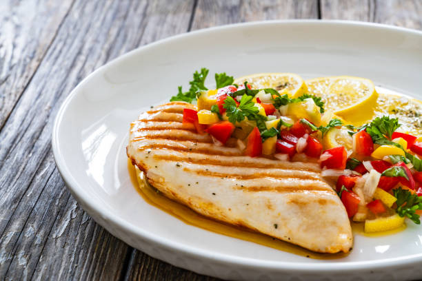 istock Grilled chicken breast and fresh vegetables on wooden table 2150909692