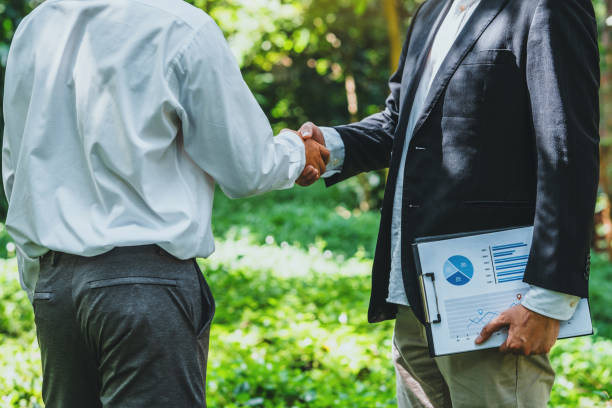 istock World Environment Day business partner colleagues shaking hands during a meeting working together in sustainability. Save Earth, World Environment Day concept, Earth Day. 2150911296