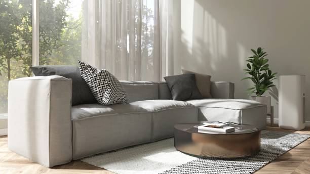 istock Modern, luxury fabric gray sofa, cushion, round coffee table in living room in sunlight, tree shadow from window 2150912467