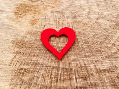 Red heart shape on wood background