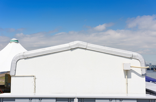 Close-up of white warehouse against blue sky with copy space.