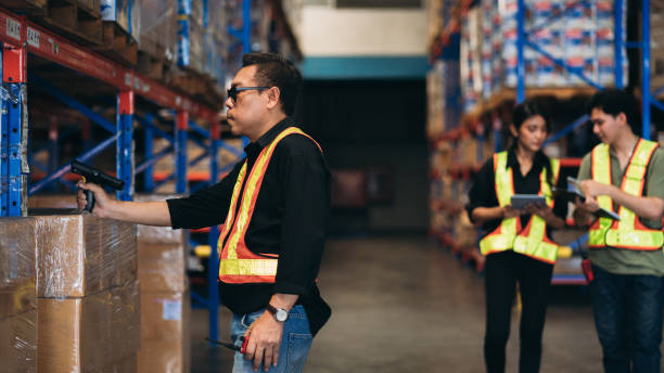 istock Warehouse worker working and checking the stock in the warehouse. .Factory manager using digital tablet check barcode in industry factory logistic. 2150918909