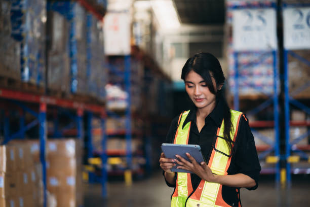 istock Warehouse worker working and checking the stock in the warehouse. .Factory manager using digital tablet check barcode in industry factory logistic. 2150918969
