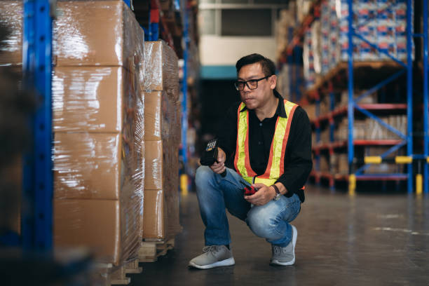 istock Warehouse worker working and checking the stock in the warehouse. .Factory manager using digital tablet check barcode in industry factory logistic. 2150919013