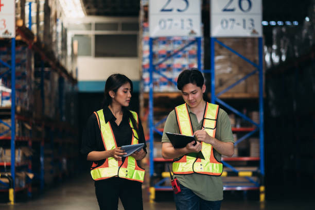 istock Warehouse worker working and checking the stock in the warehouse. .Factory manager using digital tablet check barcode in industry factory logistic. 2150919048