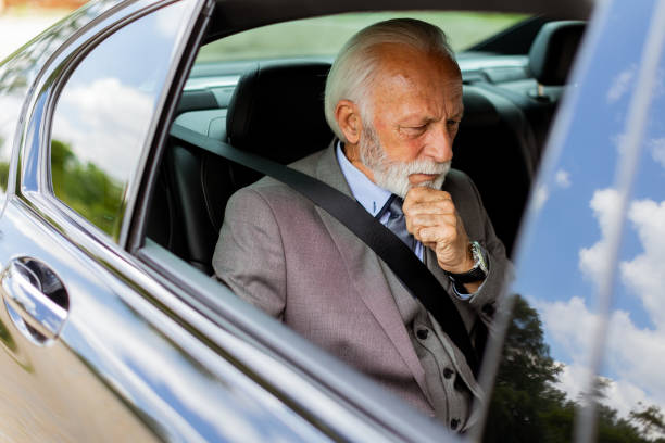 istock Elderly businessman working on laptop while parked in his car on a busy day 2150919087