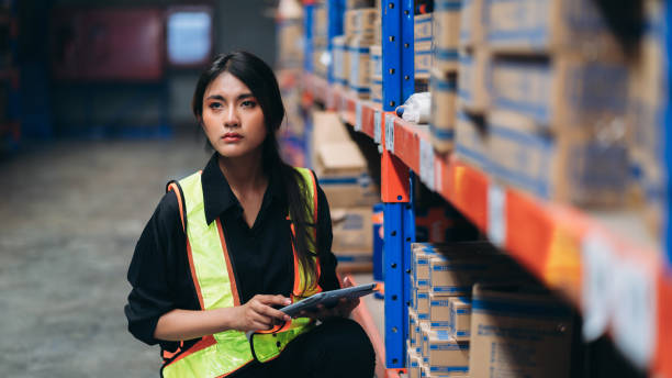 istock Warehouse worker working and checking the stock in the warehouse. .Factory manager using digital tablet check barcode in industry factory logistic. 2150919135