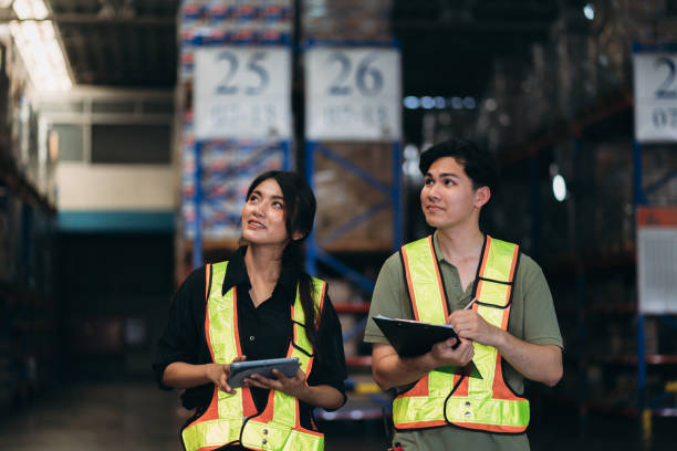 istock Warehouse worker working and checking the stock in the warehouse. .Factory manager using digital tablet check barcode in industry factory logistic. 2150919146