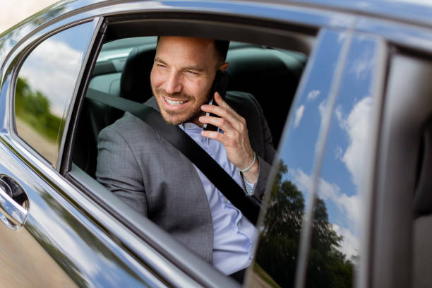 istock Joyful man sharing laughter on a phone call while driving in daylight 2150919171