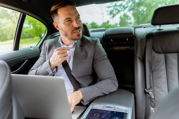 istock Business executive working on laptop in car during morning commute 2150919173