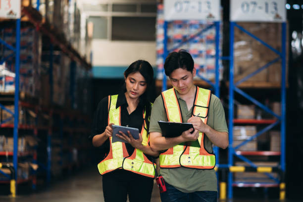 istock Warehouse worker working and checking the stock in the warehouse. .Factory manager using digital tablet check barcode in industry factory logistic. 2150919216