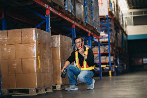 istock Warehouse worker working and checking the stock in the warehouse. .Factory manager using digital tablet check barcode in industry factory logistic. 2150919292