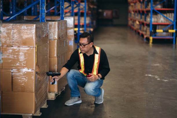 istock Warehouse worker working and checking the stock in the warehouse. .Factory manager using digital tablet check barcode in industry factory logistic. 2150919325
