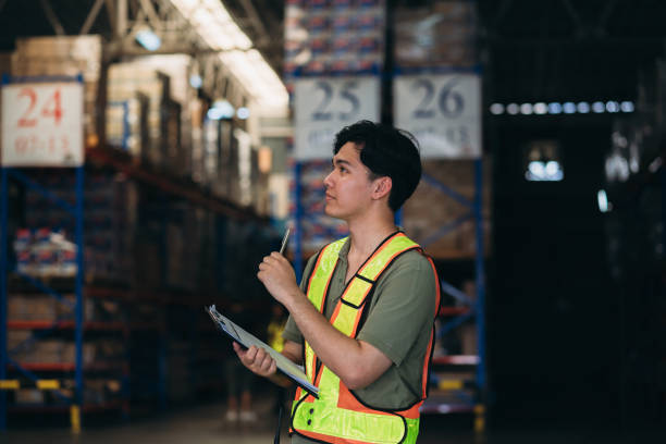Warehouse worker working and checking the stock in the warehouse. .Factory manager using digital tablet check barcode in industry factory logistic.
