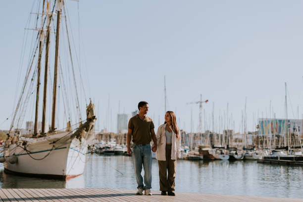 istock Serene stroll along Barcelona marina at with vintage sailing vessel 2150919342
