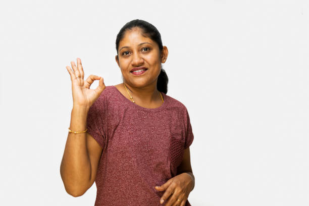 istock Woman making a super gesture in front of camera on white background 2150919769