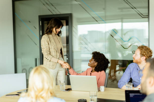 istock Warm handshake between colleagues during a sunny boardroom meeting 2150920218