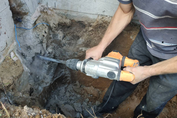 istock jackhammer in action, pneumatic construction tool, drilling a hole in the concrete wall. 2150920472