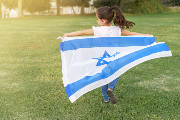 istock Happy child holding Israel flag and running. 2150922375