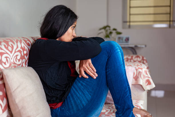 istock Sad woman sitting on sofa dejected 2150922478