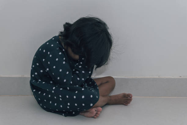 A close-up of a sad little girl crying