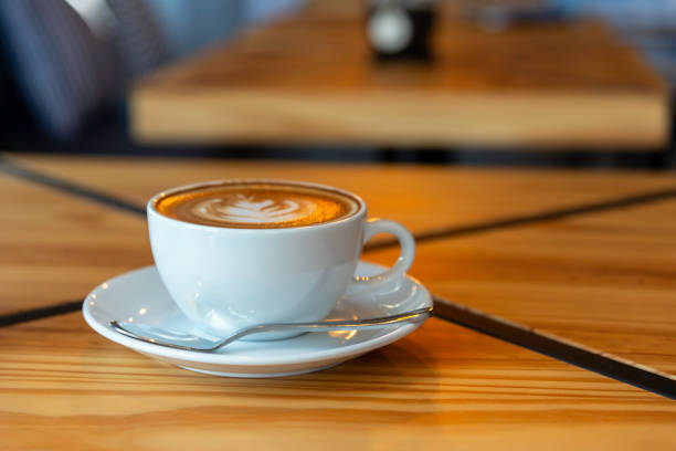 istock Hot latte art coffee cup on wooden table 2150923238