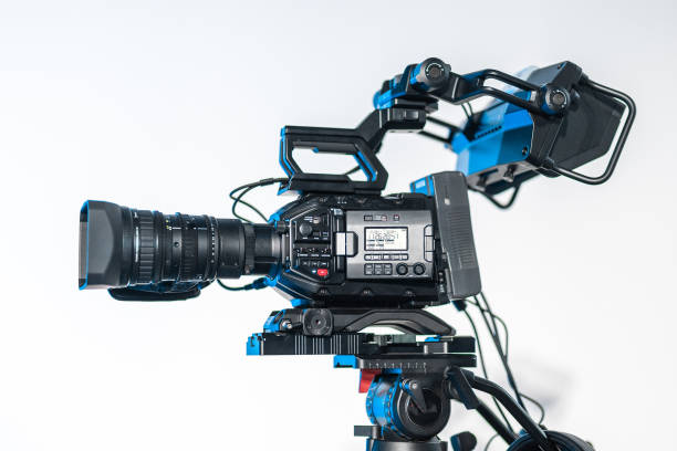 istock Side view of modern 4K broadcast cameras on a tripod. Big camera mounted on stands at a conference or event Live stream ready, professional video stream. 2150923833