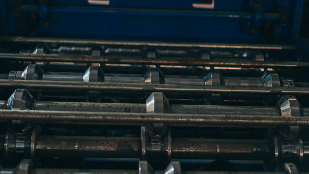 A machine with many metal rods and a blue background