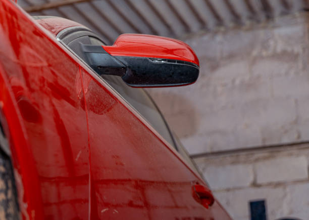 Dusty Red Car in Garage Low Angle CloseUp of Side Mirror