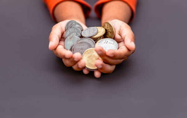 istock Indian Child Holding Coins 2150924993