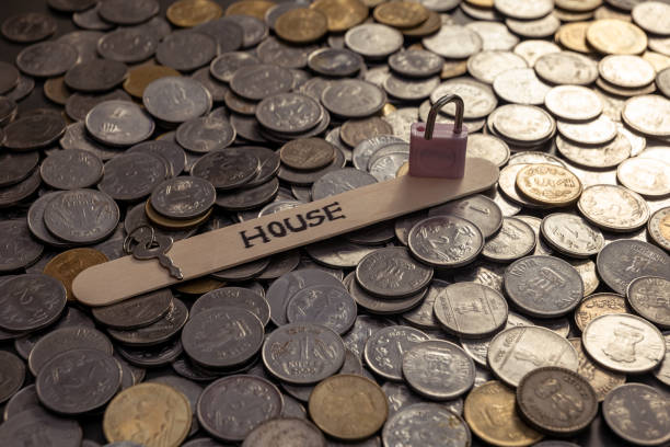 istock Indian Rupees Coins on Table with House Word Lock and Key 2150925037
