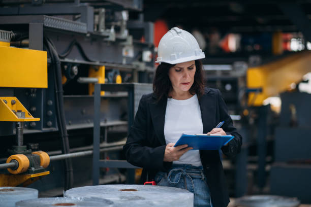 istock Industrial worker inspecting and check up machine at factory machines. Technician working in metal sheet at industry. Foreman checking Material or Machine. 2150925070