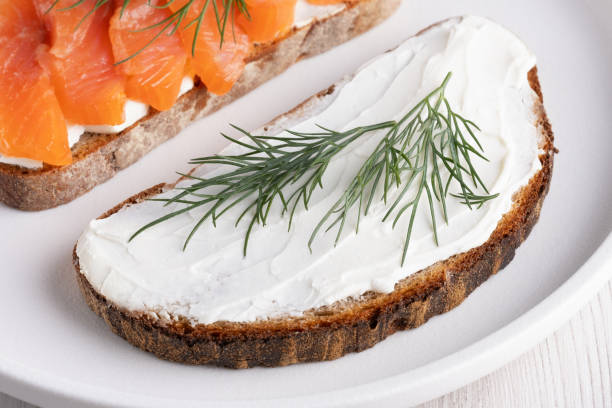 istock Rye sandwich with cream cheese and salmon on white wooden table 2150925165