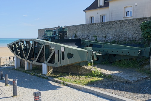 Arromanches-les-Bains, France - Apr 29, 2024: What remain of Arromanches artificial port (Mulberry B) during Second World War. Whale and Phoenix Caissons. Selective focus.