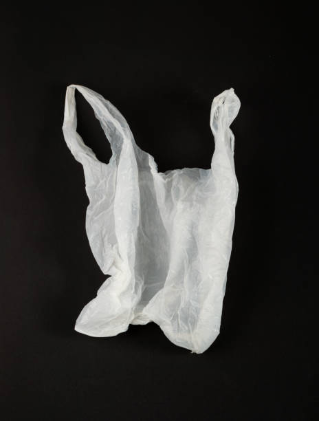 istock White Plastic Bags on Black Background, Crumpled Plastic Bag after Shopping, Cellophane Packaging Waste 2150927968