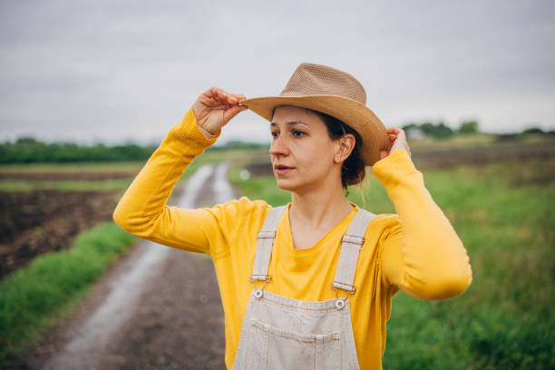 istock Farmer adjusting hat in countryside 2150930108