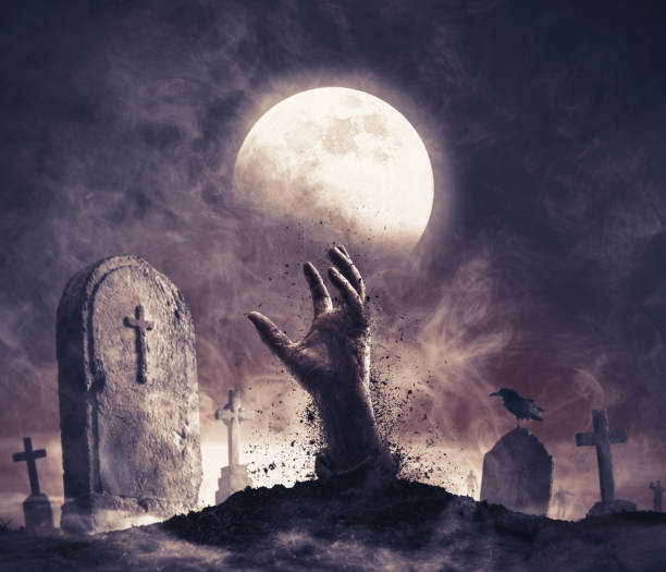 istock Zombie rising from the grave in the cemetery 2150931166