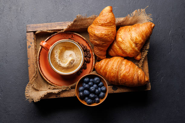 istock Cappuccino coffee and fresh croissants 2150931646