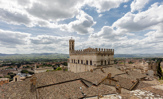 Gubbio, Italy - April 27, 2024: Overlook on the old town, with the Palazzo dei Consoli (Palace of the Consuls).