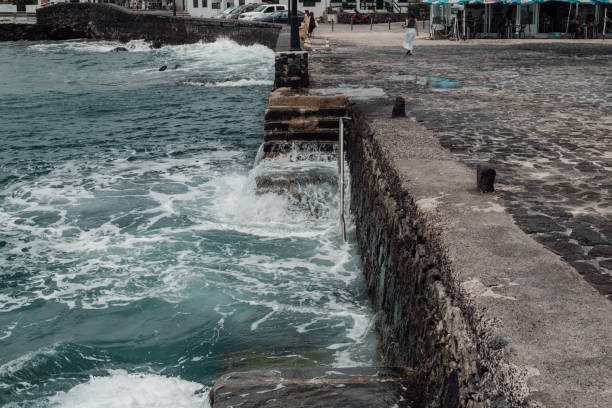 istock Strong waves wash over a staircase on the pier 2150935194