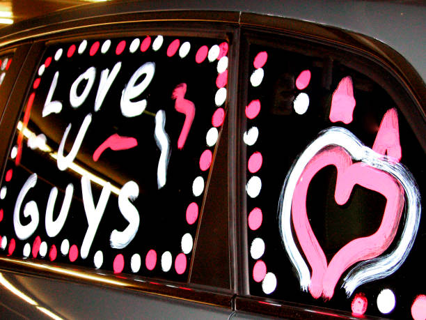 Love sign and heart shape written on car  windshield. Toronto, Canada.