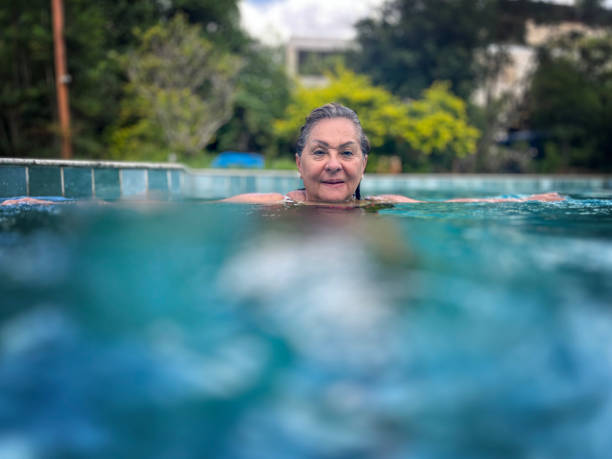 istock Senior Hispanic woman in swimming pool 2150936676