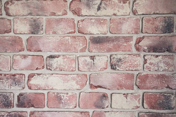 istock Textured background of a worn brick wall. Brickwork background for your design, vintage old pattern, uneven color with space to copy 2150937018