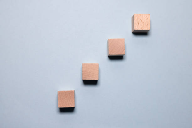 istock Hand putting and stacking blank wooden cubes on table with copy space for input wording and infographic icon. 2150937318