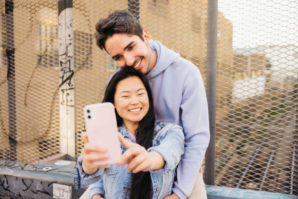 istock Couple on a date taking a selfie in a city. 2150938411