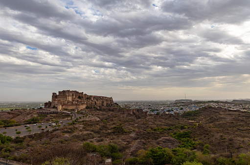 ancient historical fort with dramatic cloudy sky at evening from flat angle image is taken at mehrangarh fort jodhpur rajasthan india.