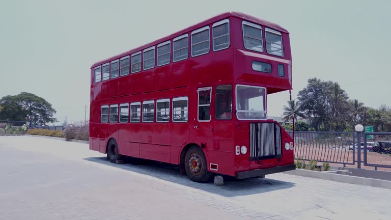 A Pan view of a Double Decker Bus in red color used as popular Public Transportation for the tourists visiting England and India.
