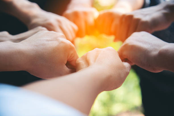 istock Diverse multiethnic Partners hands together teamwork group of multiracial people meeting join hands togetherness. Diversity people hands join empower partnership teams connection volunteer community 2150943909